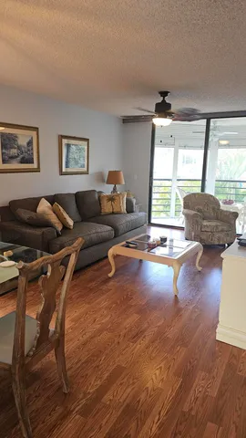 a living room with furniture dining table and a large window