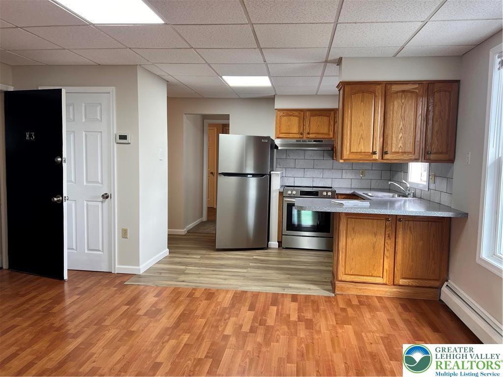 402 Prospect Avenue, Unit E3 Bethlehem, PA 18018 - Photo 3 of 19 a kitchen with stainless steel appliances granite countertop a refrigerator a sink dishwasher a stove and a microwave oven
