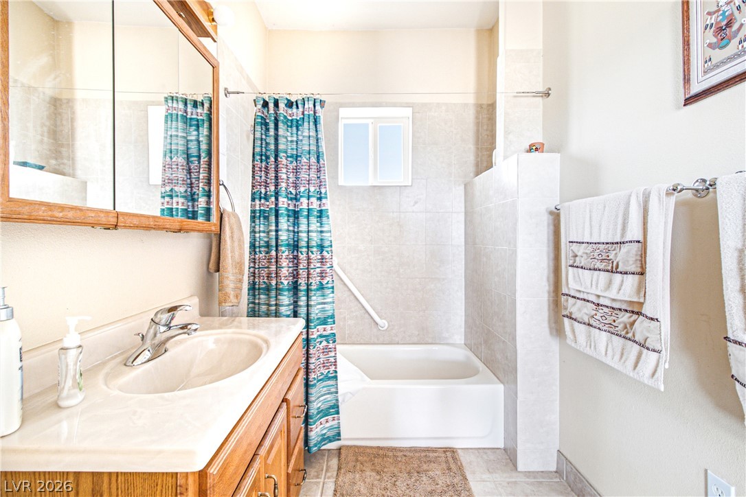 Rocking S Ranch Road Searchlight, NV 89046 - Photo 28 of 47 A well-appointed bathroom offers a convenient vanity, tub, and tiled surrounds for daily routines.