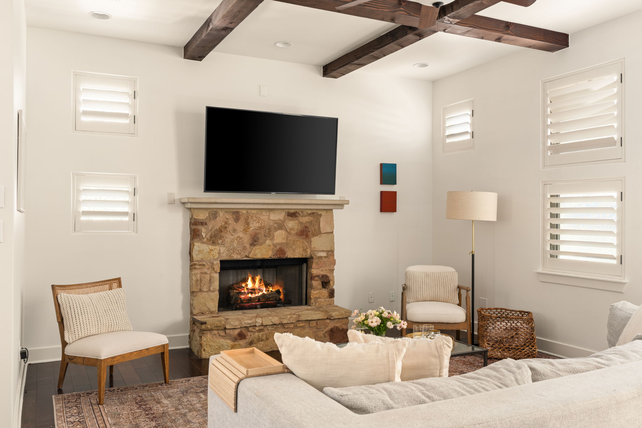 2324 Kinney Road Austin, TX 78704 - Photo 5 of 35 Exposed wood beams and a rustic stone fireplace anchor this warm living space.
