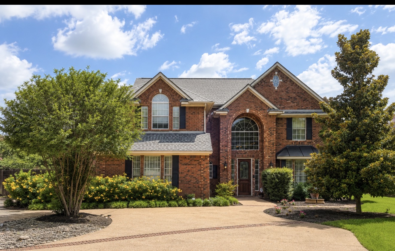 13 Oak View Round Rock, TX 78664 - Photo 1 of 30 A classic brick facade with arched windows frames the welcoming entry, complemented by mature landscaping.