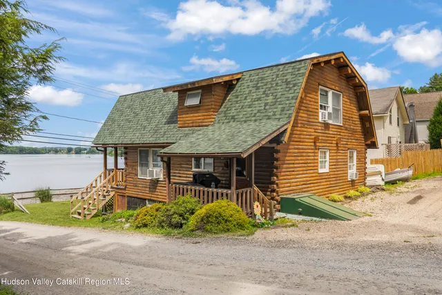 a front view of a house with a garden and plants