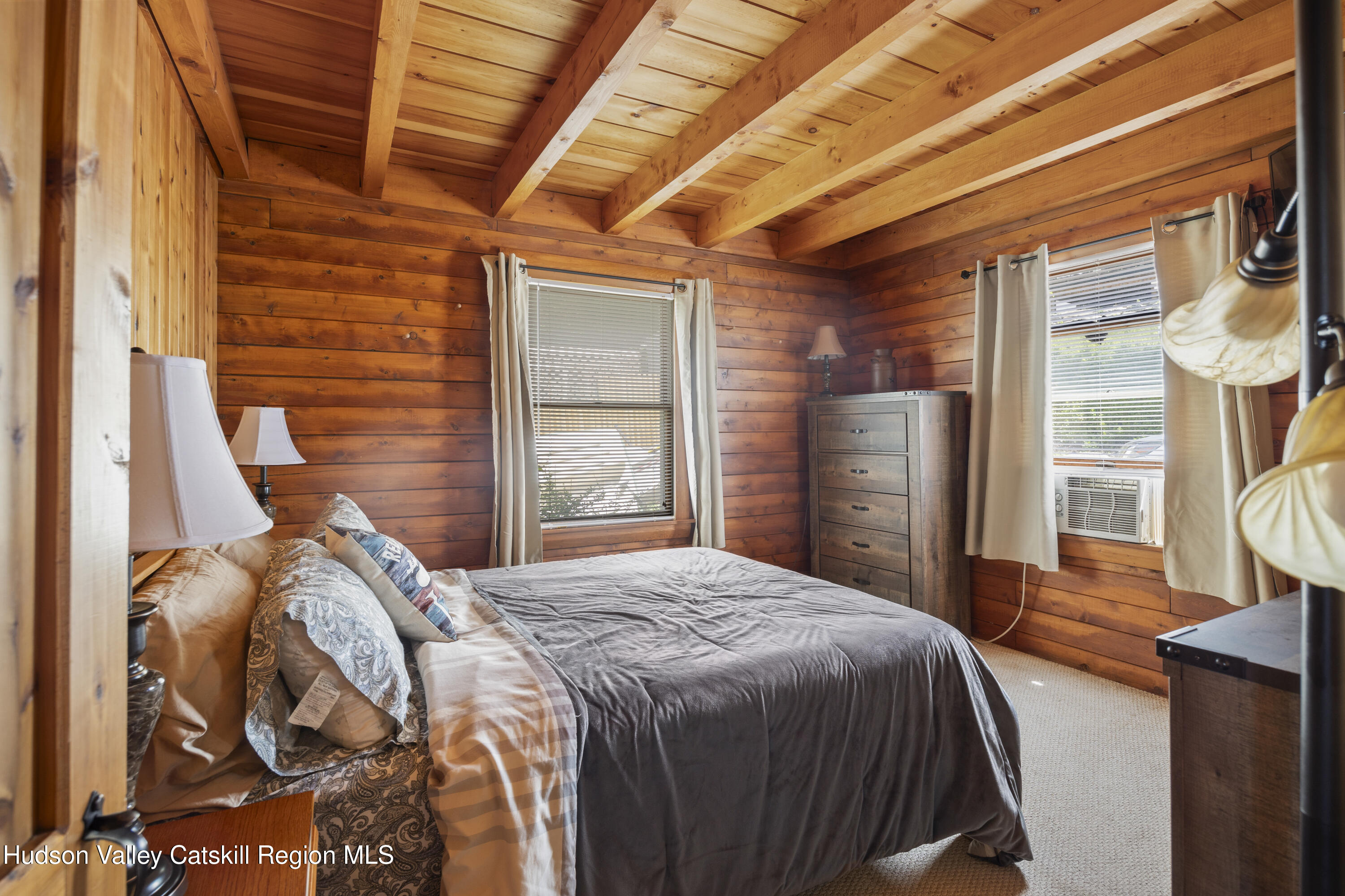 407 Lakeview Road Craryville, NY 12521 - Photo 12 of 24 a bedroom with a bed next to a window