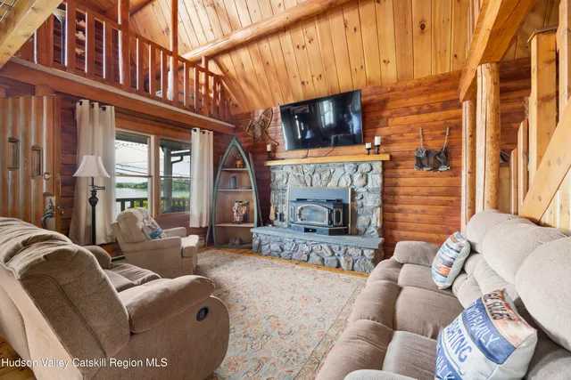 a living room with furniture a flat screen tv and a fireplace