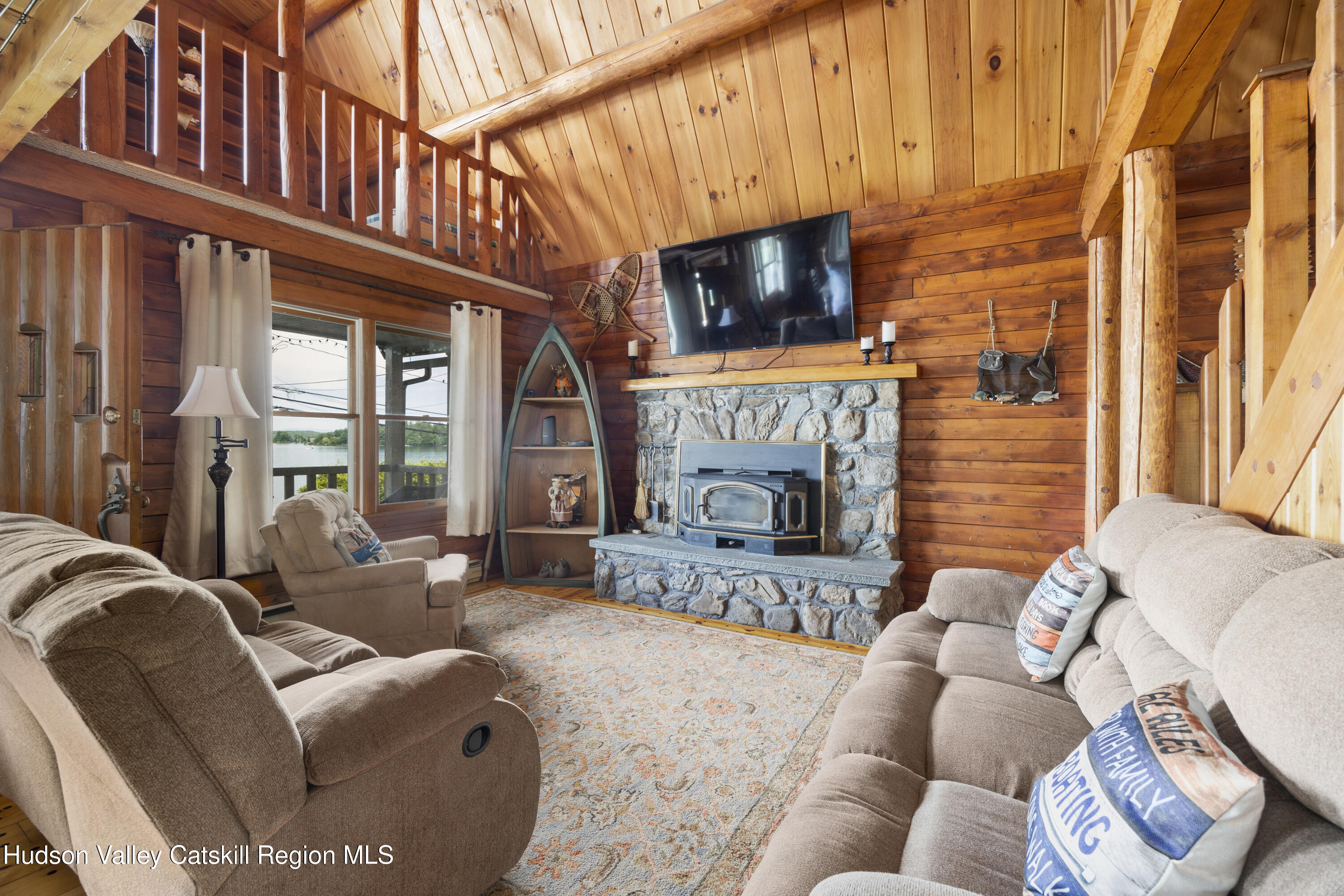 407 Lakeview Road Craryville, NY 12521 - Photo 6 of 24 a living room with furniture a flat screen tv and a fireplace