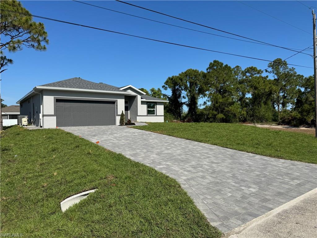 829 Albert Avenue Lehigh Acres, FL 33971 - Photo 1 of 27 a view of a house with a yard