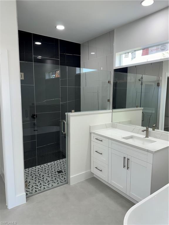 829 Albert Avenue Lehigh Acres, FL 33971 - Photo 16 of 27 a bathroom with a shower a sink and a mirror