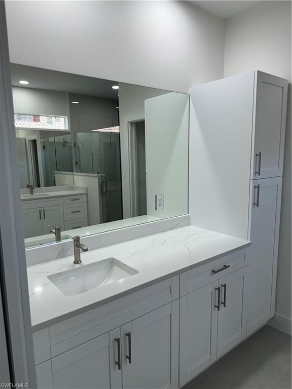 829 Albert Avenue Lehigh Acres, FL 33971 - Photo 18 of 27 a bathroom with a sink and a mirror