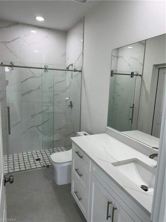 829 Albert Avenue Lehigh Acres, FL 33971 - Photo 22 of 27 a bathroom with a sink a toilet and shower