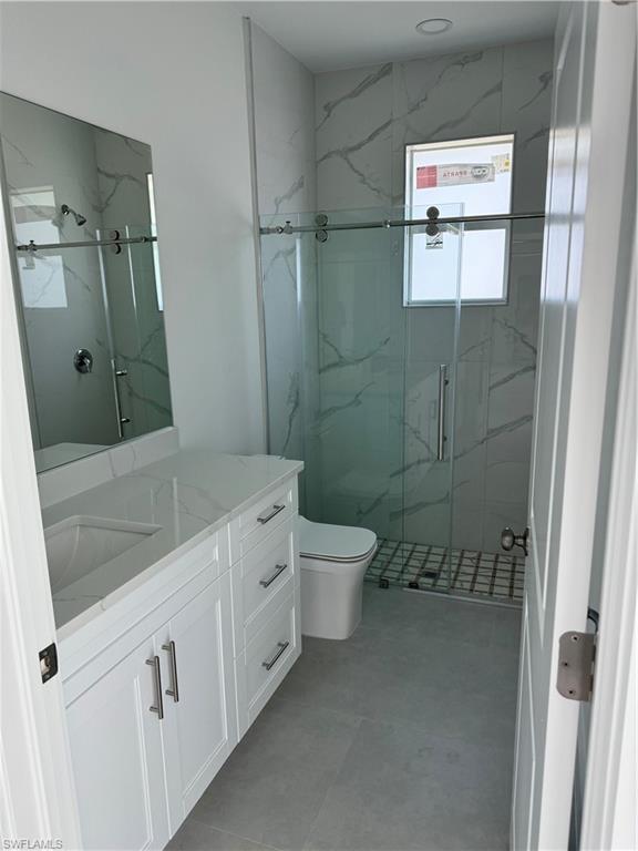 829 Albert Avenue Lehigh Acres, FL 33971 - Photo 23 of 27 a bathroom with a granite countertop sink toilet and shower