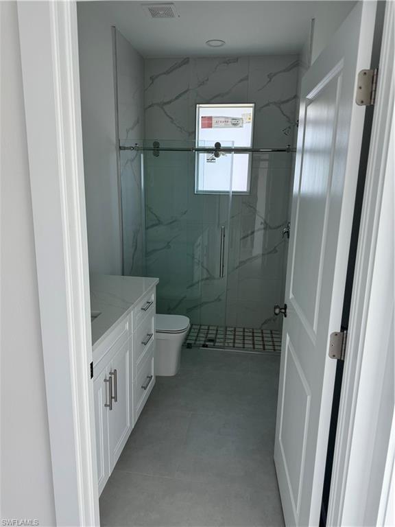 829 Albert Avenue Lehigh Acres, FL 33971 - Photo 25 of 27 a bathroom with a sink and a mirror