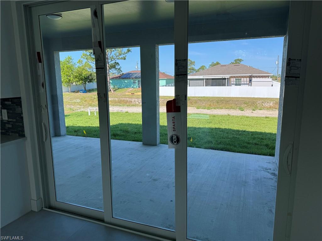 829 Albert Avenue Lehigh Acres, FL 33971 - Photo 27 of 27 a view of a yard from a window