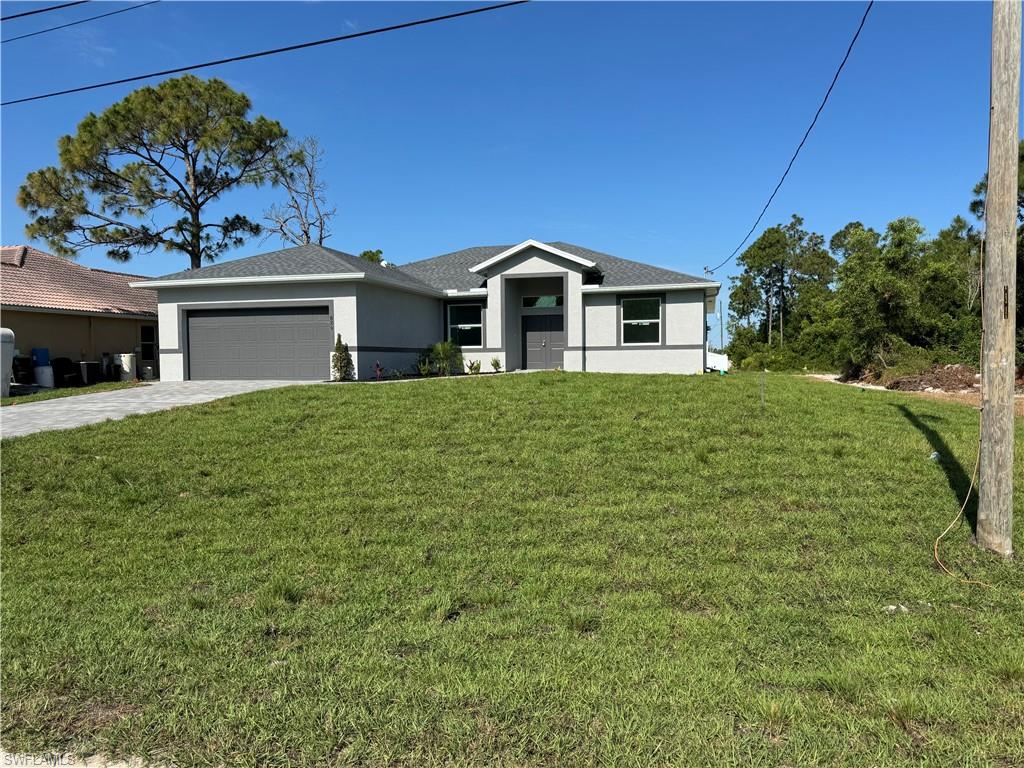 829 Albert Avenue Lehigh Acres, FL 33971 - Photo 3 of 27 a front view of a house with a yard