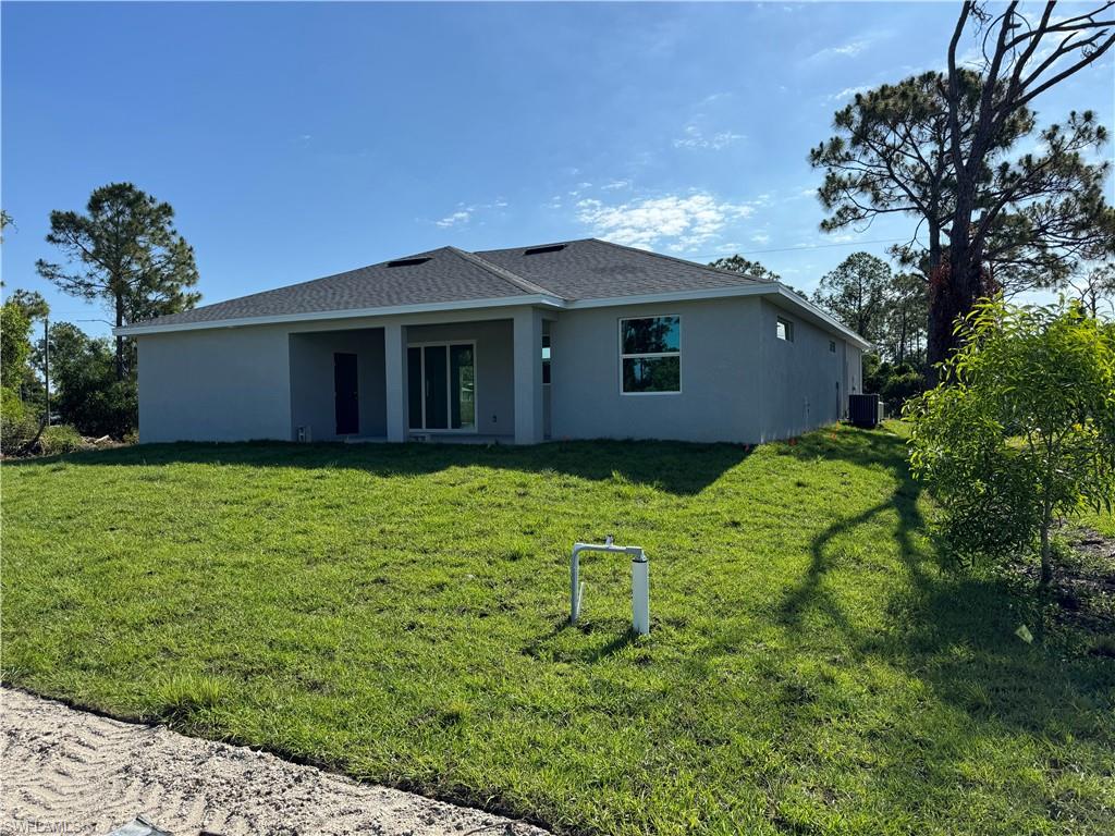 829 Albert Avenue Lehigh Acres, FL 33971 - Photo 5 of 27 a house with a yard