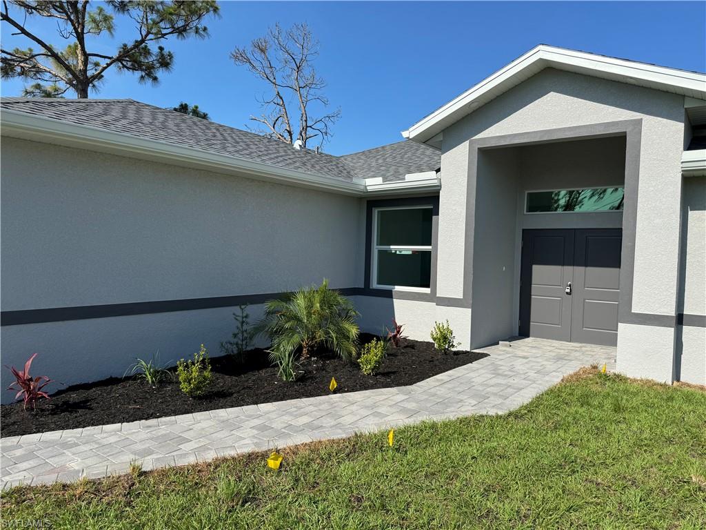 829 Albert Avenue Lehigh Acres, FL 33971 - Photo 6 of 27 a front view of a house with a yard