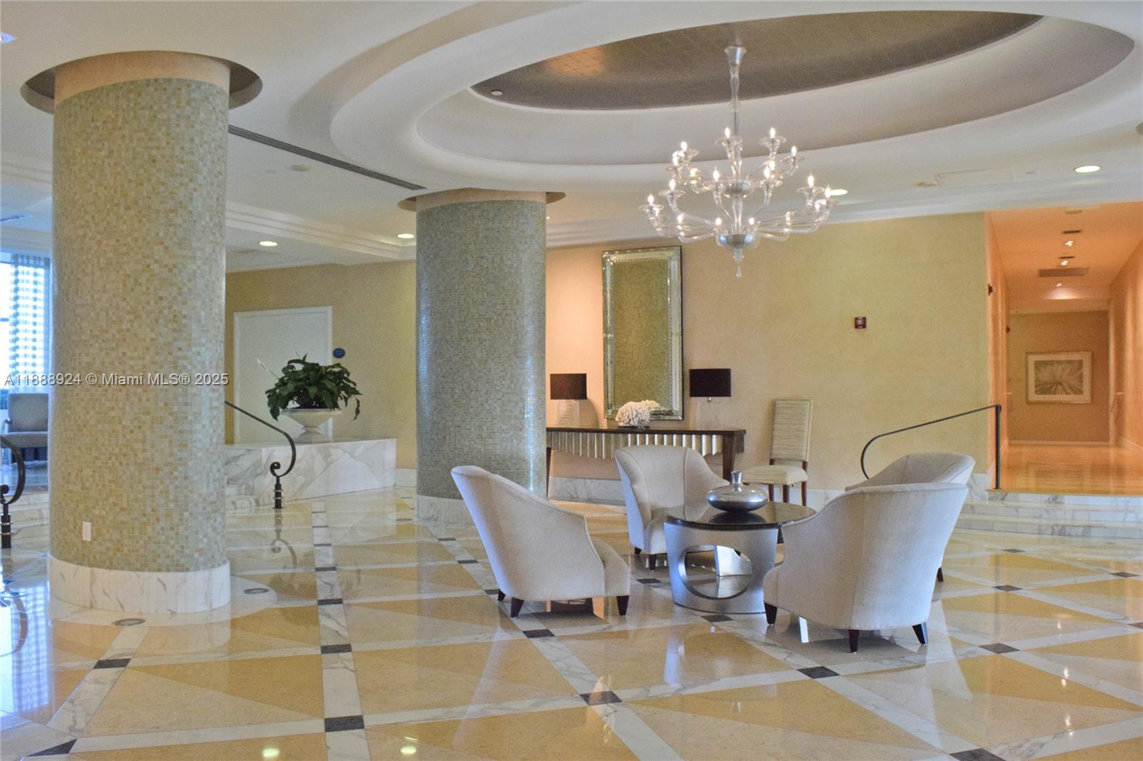 6917 Collins Avenue, Unit 1512 Miami Beach, FL 33141 - Photo 14 of 15 a view of a dining room with furniture and chandelier