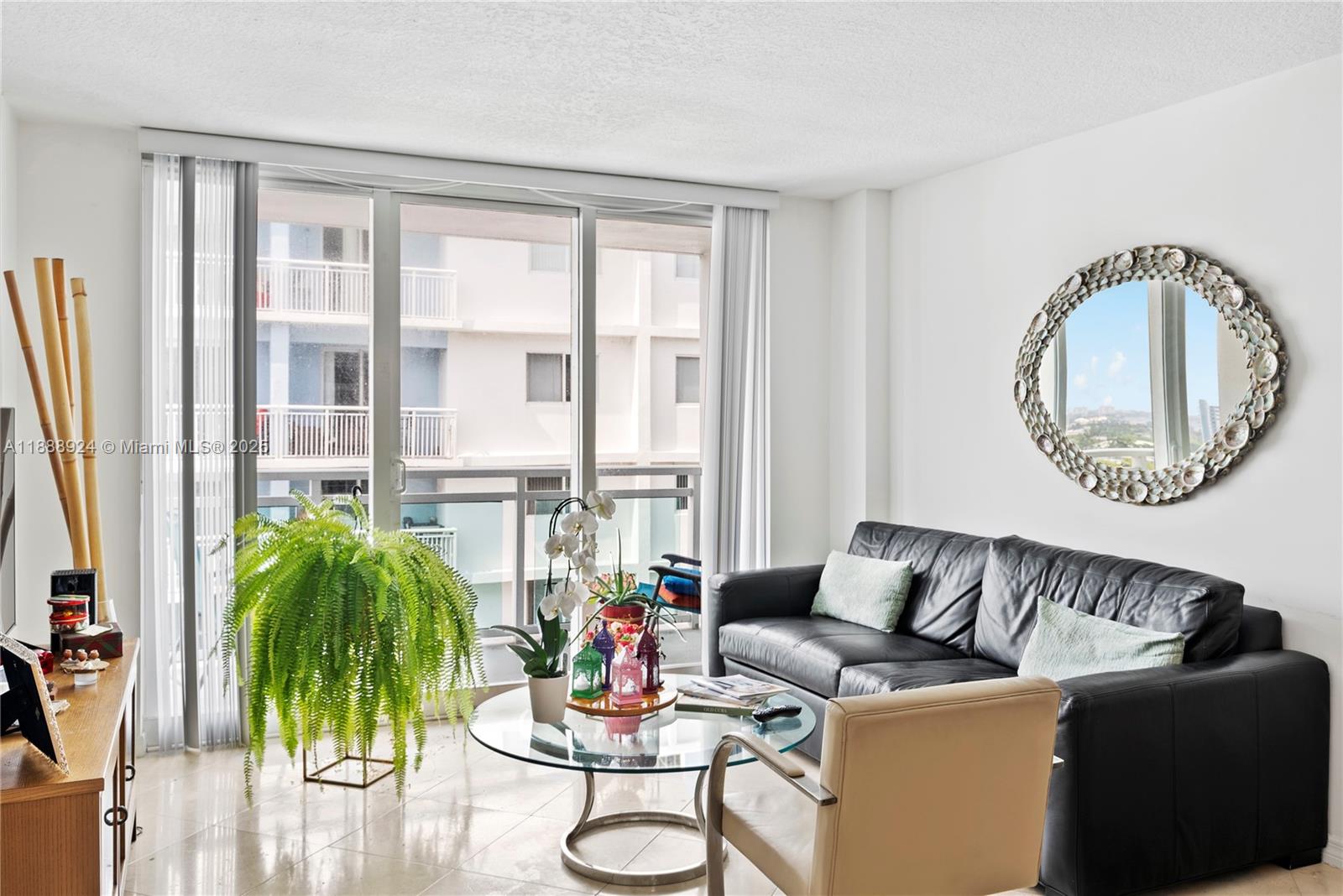 6917 Collins Avenue, Unit 1512 Miami Beach, FL 33141 - Photo 3 of 15 a living room with furniture and a large window