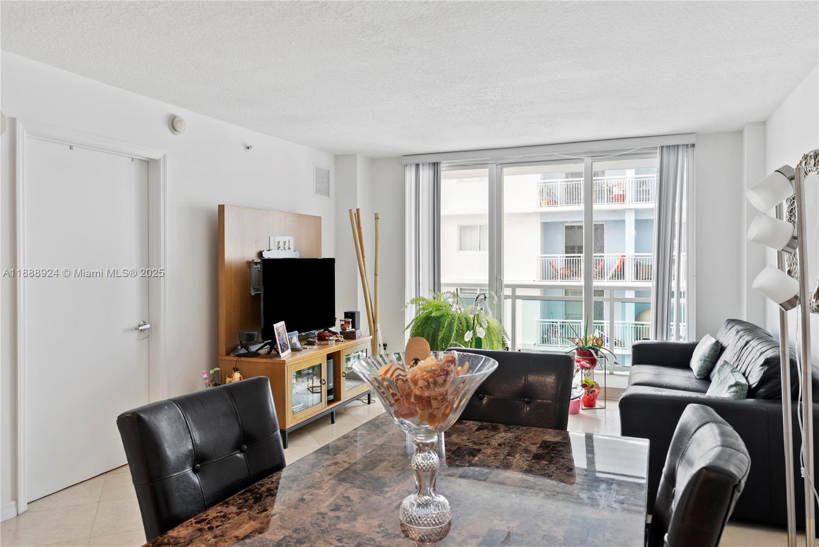 6917 Collins Avenue, Unit 1512 Miami Beach, FL 33141 - Photo 4 of 15 a living room with furniture or outdoor view and a large window