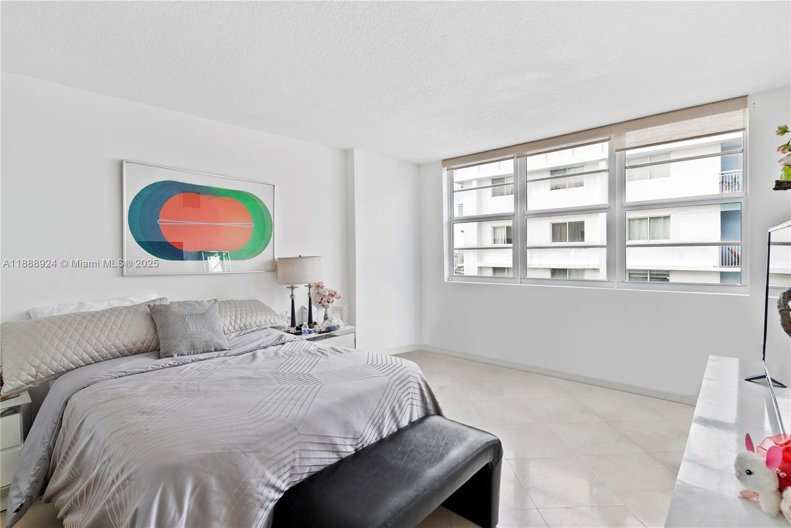 6917 Collins Avenue, Unit 1512 Miami Beach, FL 33141 - Photo 9 of 15 a bedroom with a bed and a large window