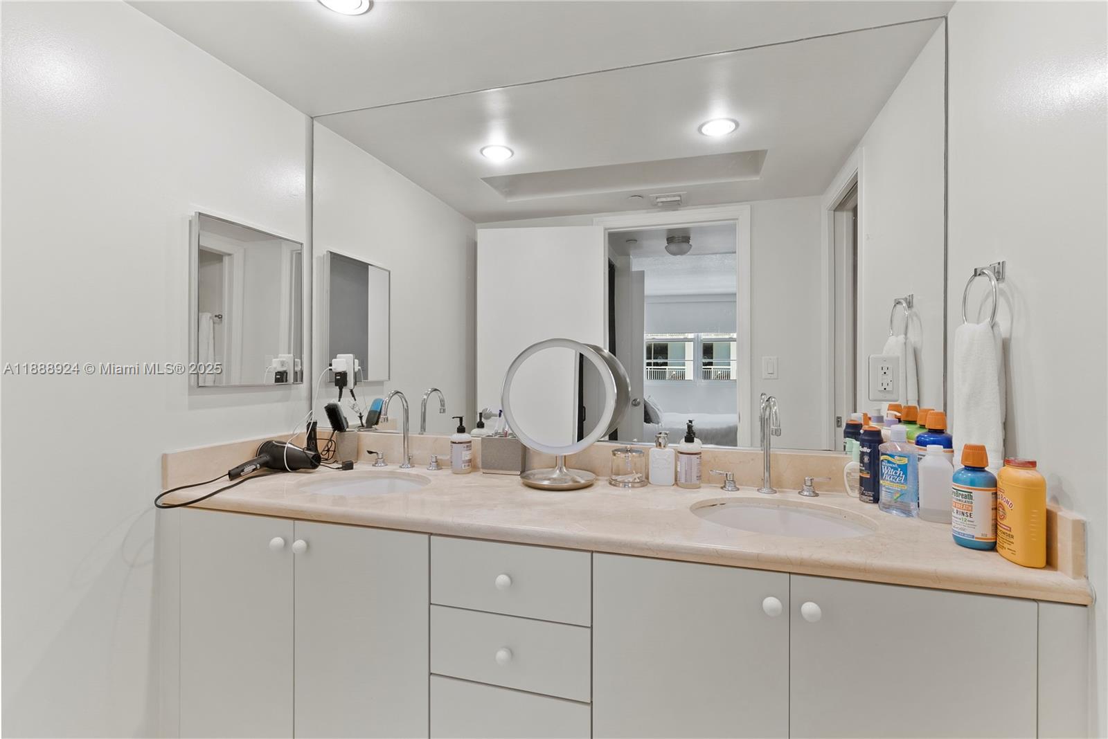 6917 Collins Avenue, Unit 1512 Miami Beach, FL 33141 - Photo 10 of 15 a bathroom with a sink and a mirror