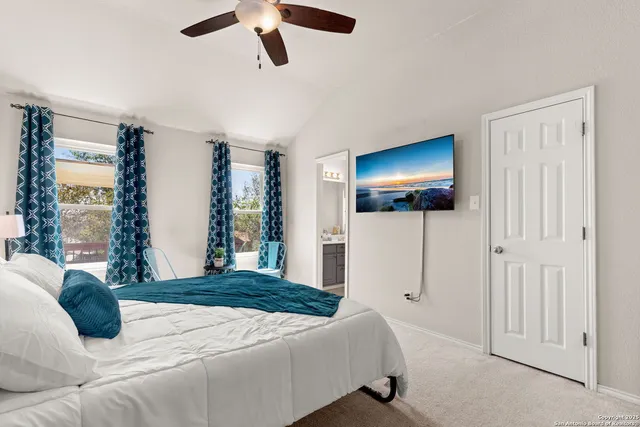 a bedroom with a bed and a flat tv screen