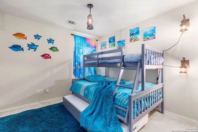 a bedroom with furniture and wooden floor