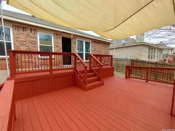 a view of balcony with wooden floor and fence