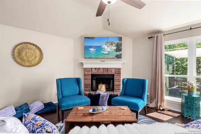 a living room with furniture fireplace and window