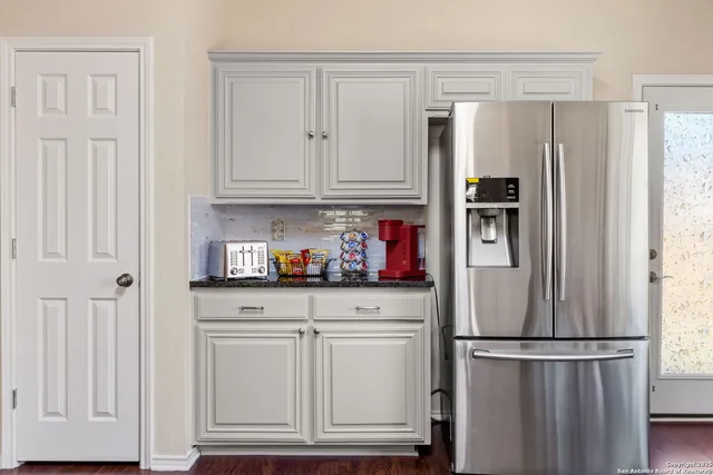 a kitchen with stainless steel appliances granite countertop a refrigerator sink and cabinets