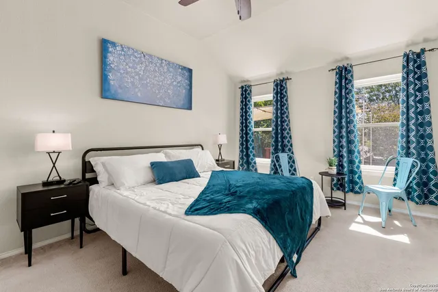 a bedroom with a bed and lamp