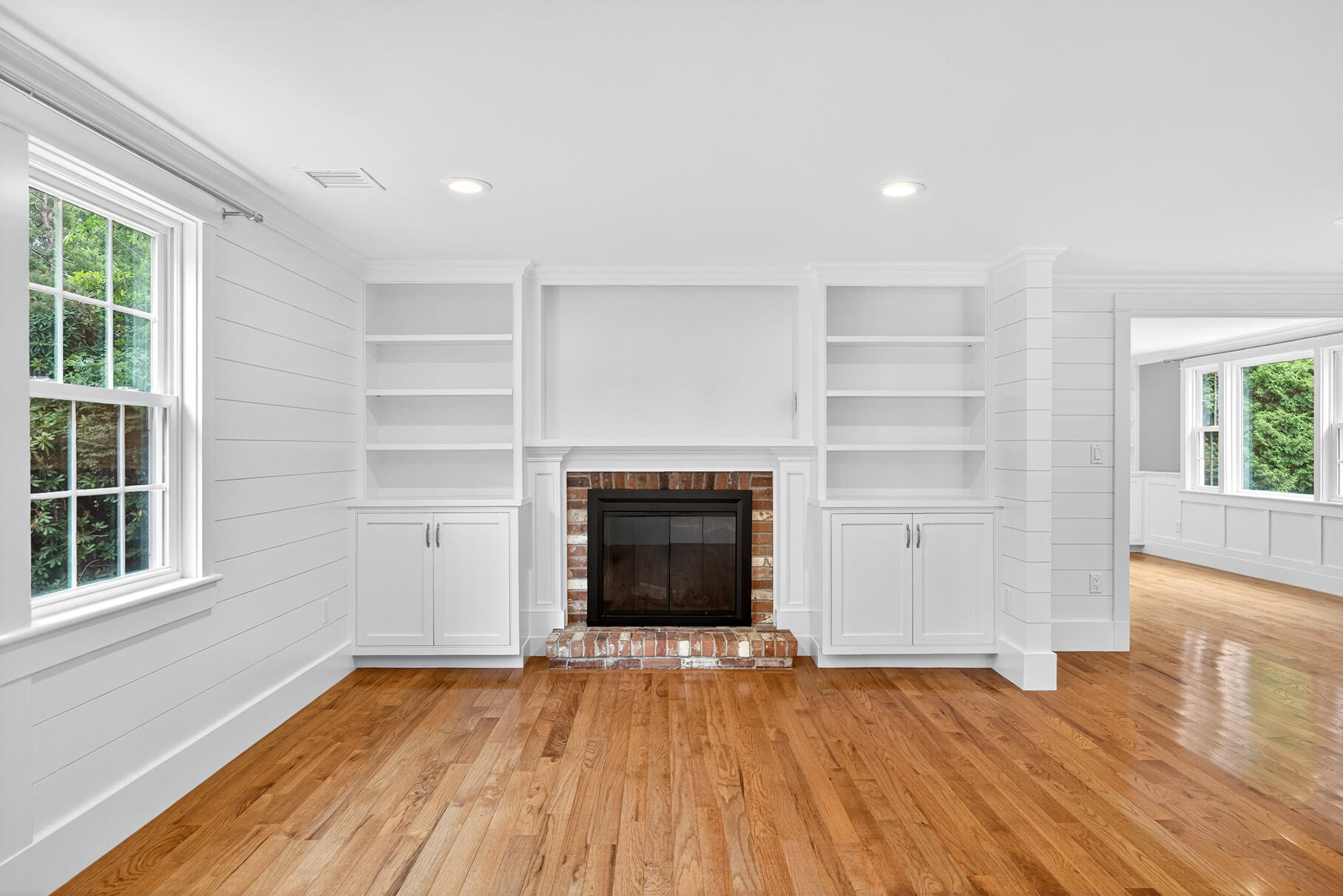 28 Stoney Cliff Road Centerville, MA 02632 - Photo 3 of 27 an empty room with wooden floor fireplace and windows
