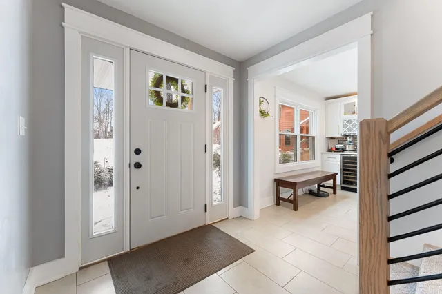 a view of kitchen with cabinets and window