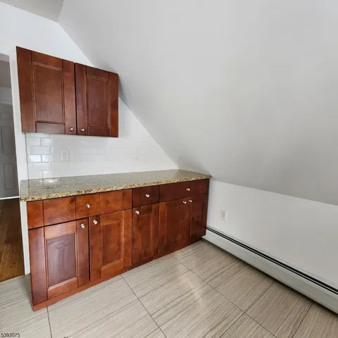 a kitchen with granite countertop cabinets and white appliances