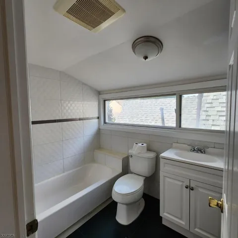 a bathroom with a sink a toilet and bathtub