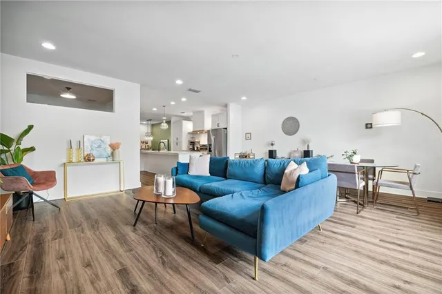 a living room with furniture and wooden floor