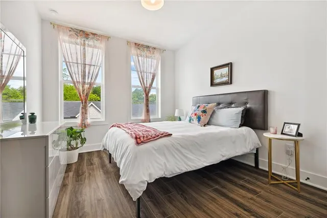 a bedroom with a bed and wooden floor