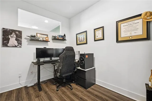 a view of a workspace with furniture and wooden floor
