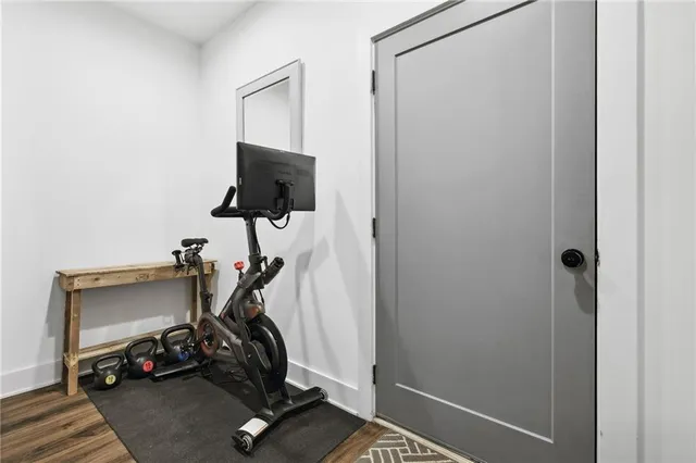 a room with gym equipment and windows