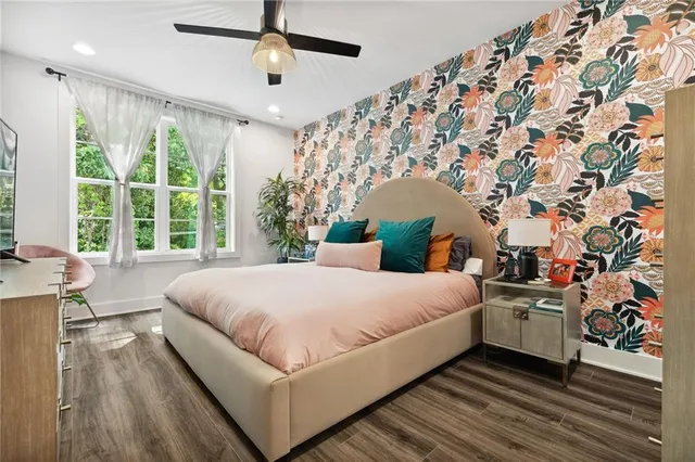 a bedroom with a large bed and a chandelier