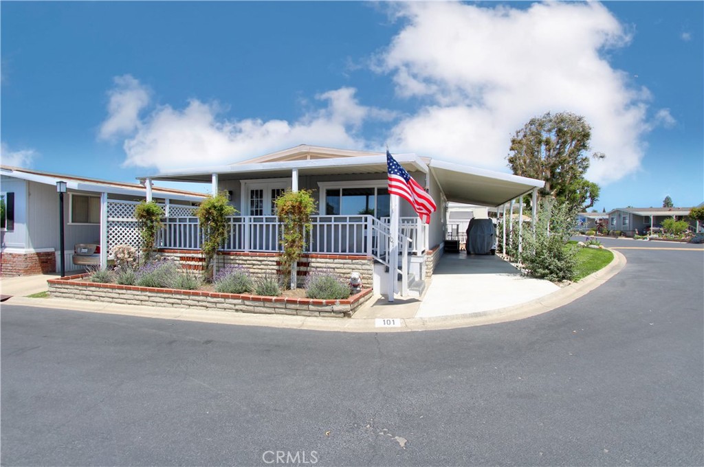a view of a house with a big yard and potted plants