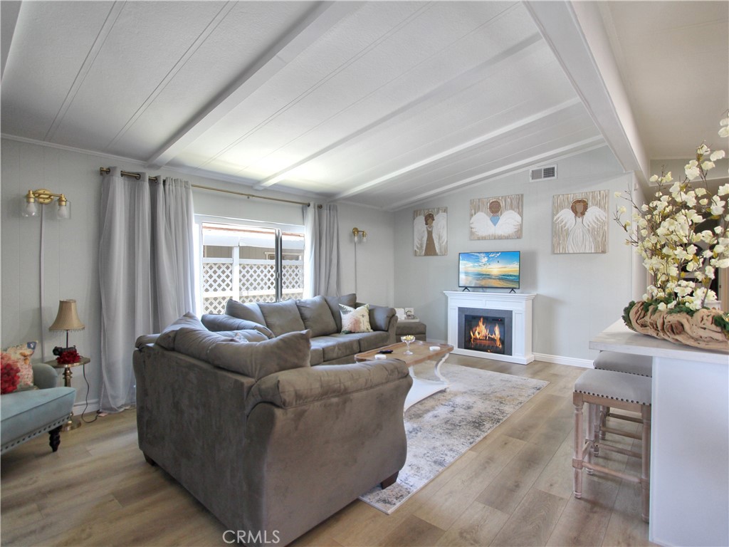 692 North Adele Street, Unit 101 Orange, CA 92867 - Photo 11 of 20 a living room with furniture a fireplace and a window