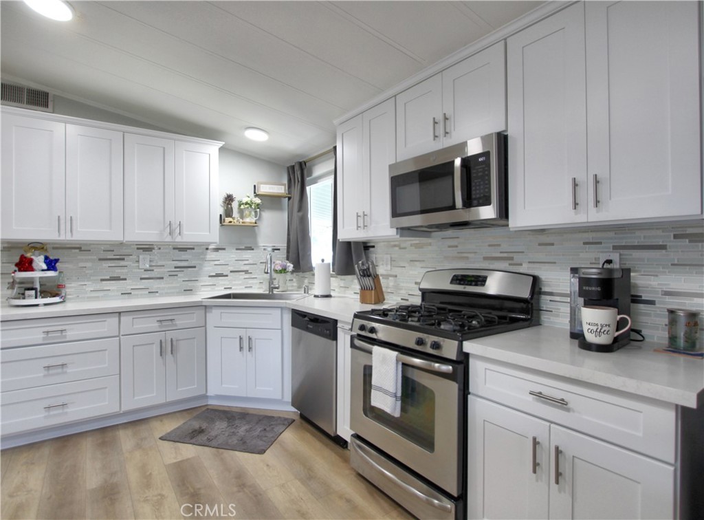 692 North Adele Street, Unit 101 Orange, CA 92867 - Photo 8 of 20 a kitchen with cabinets stainless steel appliances and a sink