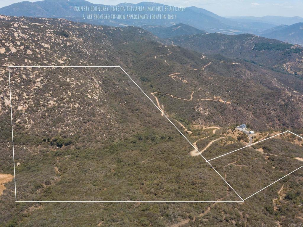 a view of a dry yard with mountain view