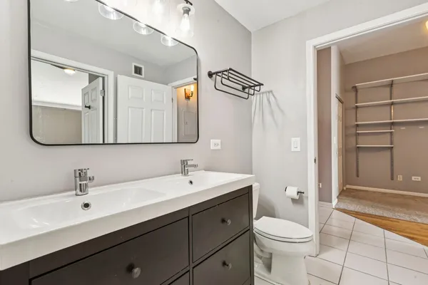 a bathroom with a shower and closet