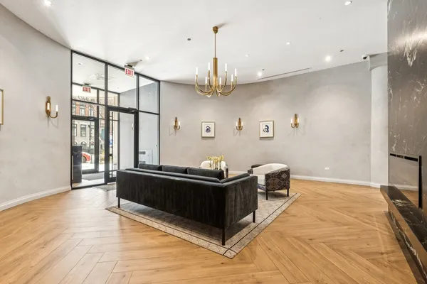 a living room with furniture a couch and a chandelier