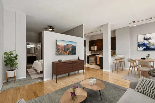 a living room with furniture and wooden floor
