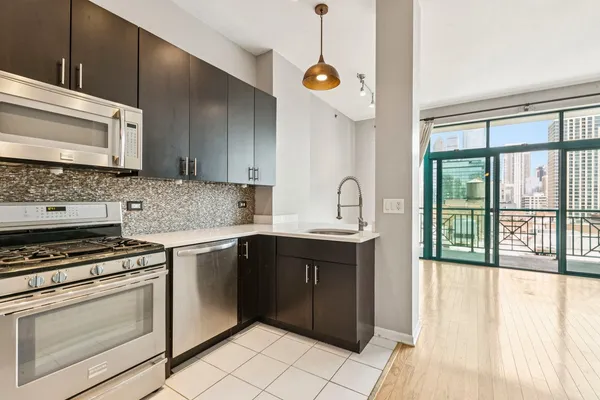 a kitchen with a stove sink and cabinets