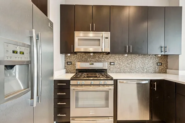 a kitchen with a stove microwave and refrigerator