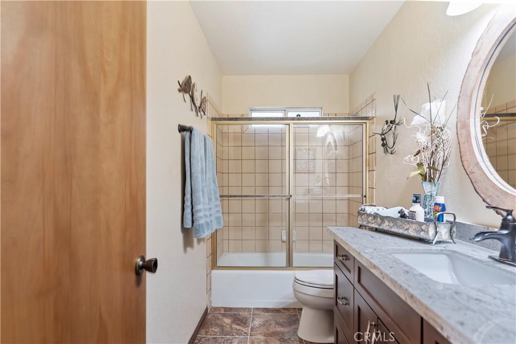 615 Wellesley Lake Arrowhead, CA 92352 - Photo 11 of 45 a bathroom with a sink a toilet and shower curtain