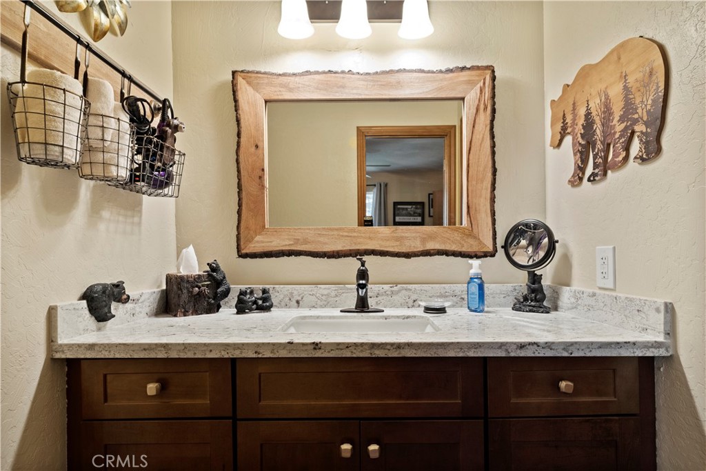 615 Wellesley Lake Arrowhead, CA 92352 - Photo 13 of 45 a bathroom with a sink and a mirror